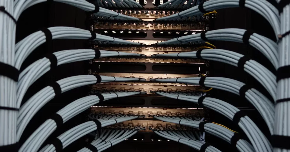 Rows of GPU servers in a data center hall representing AI compute capacity