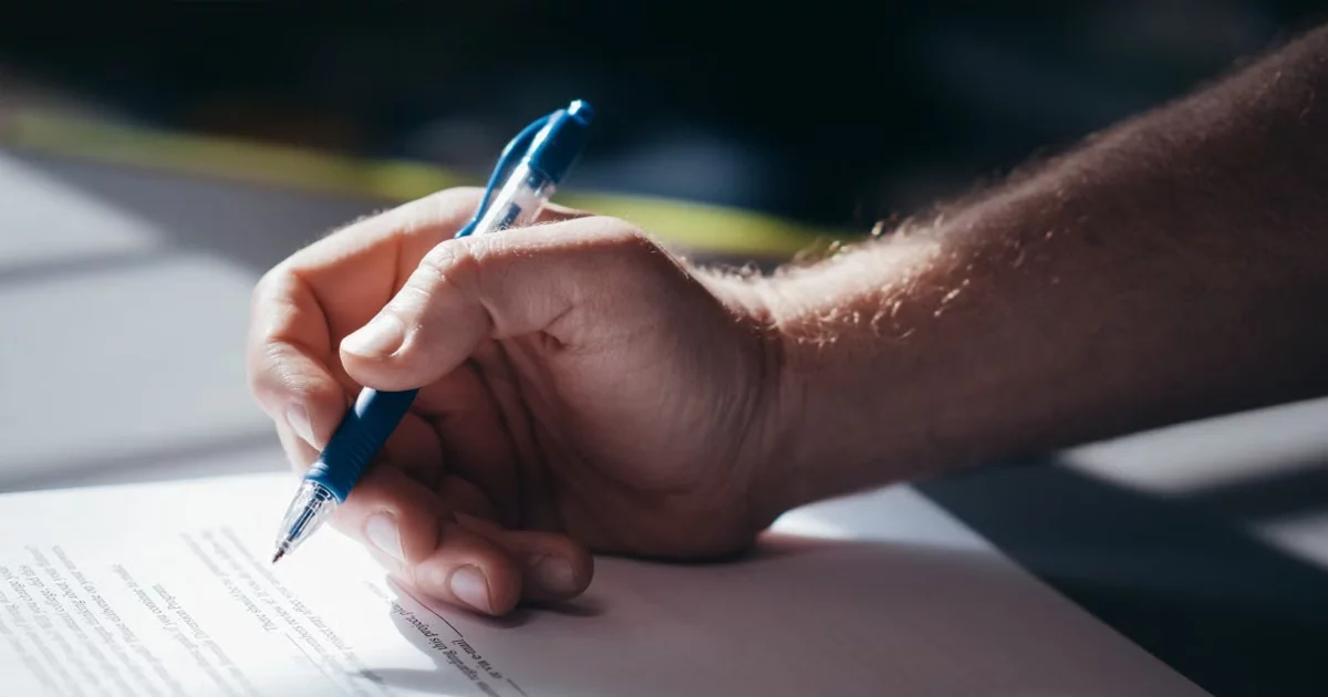 Signed contract documents on a desk representing corporate contract announcements